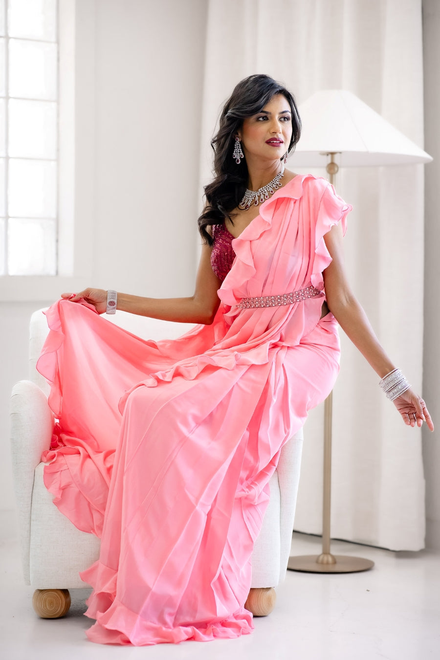 pink saree dress Sequined Blush pink Saree-Style Gown: This ensemble features a heavily embellished lavender or dusty rose fabric with intricate sequin work. The blouse has cold-shoulder sleeves adorned with delicate beaded fringe, while the