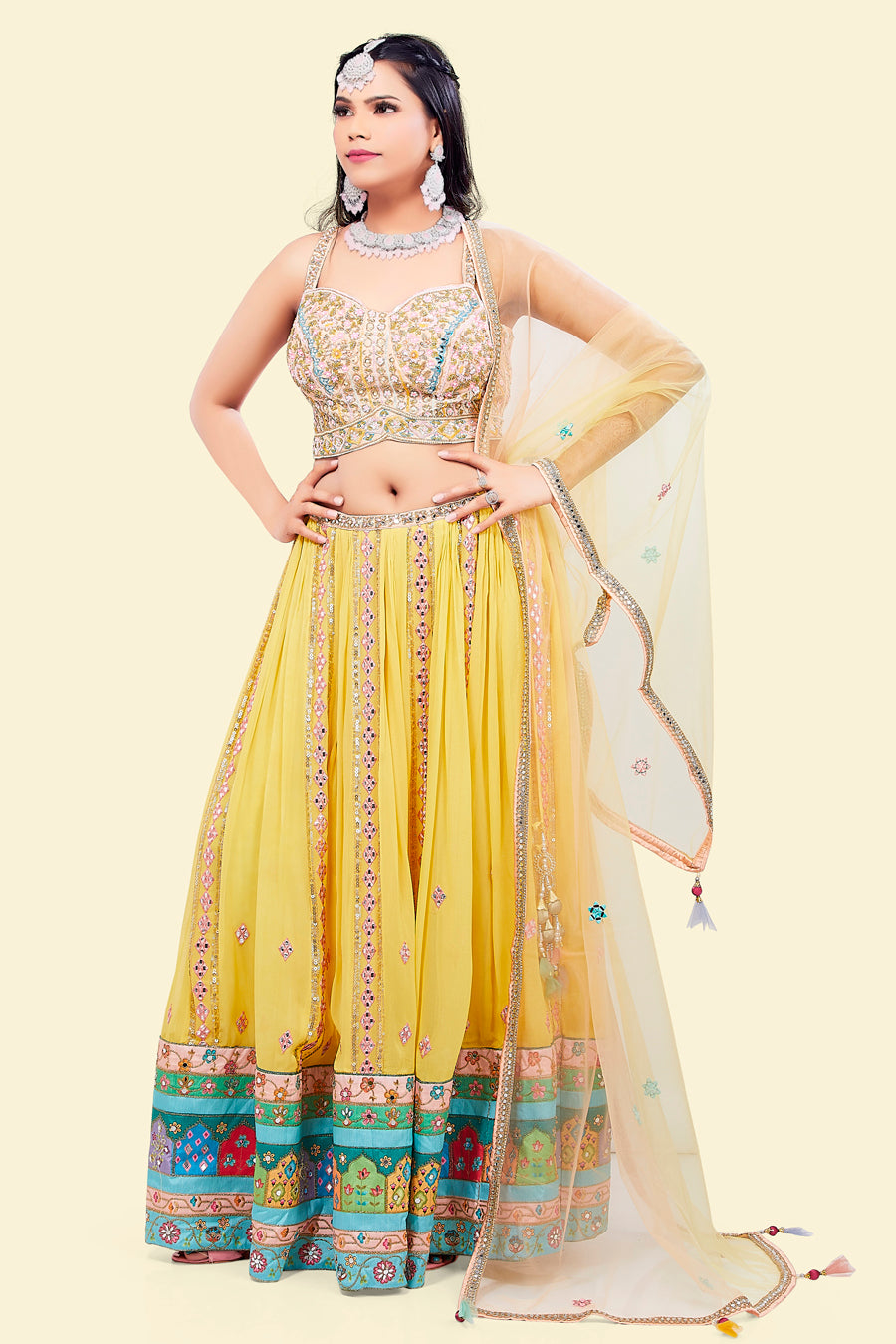 Yellow Lehenga with multicolor border and Pink Mirror Choli