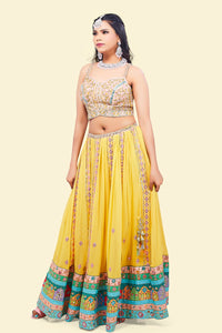Yellow Lehenga with multicolor border and Pink Mirror Choli