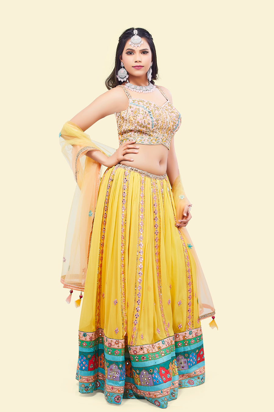 Yellow Lehenga with multicolor border and Pink Mirror Choli