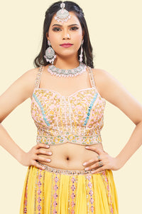 Yellow Lehenga with multicolor border and Pink Mirror Choli