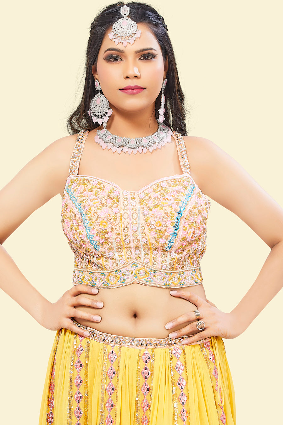 Yellow Lehenga with multicolor border and Pink Mirror Choli