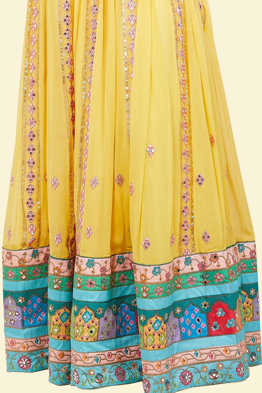 Yellow Lehenga with multicolor border and Pink Mirror Choli